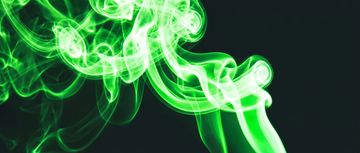 Vibrant green vapor swirling on a black background